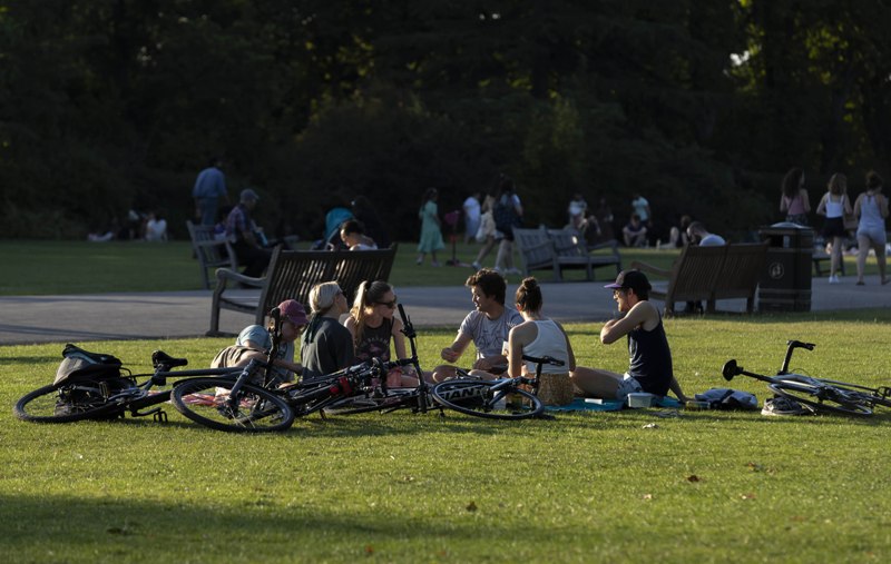 People spend time outside amid hot weather in London