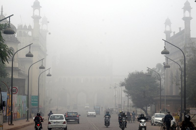 A man cycles in a fog covered morning in Lucknow