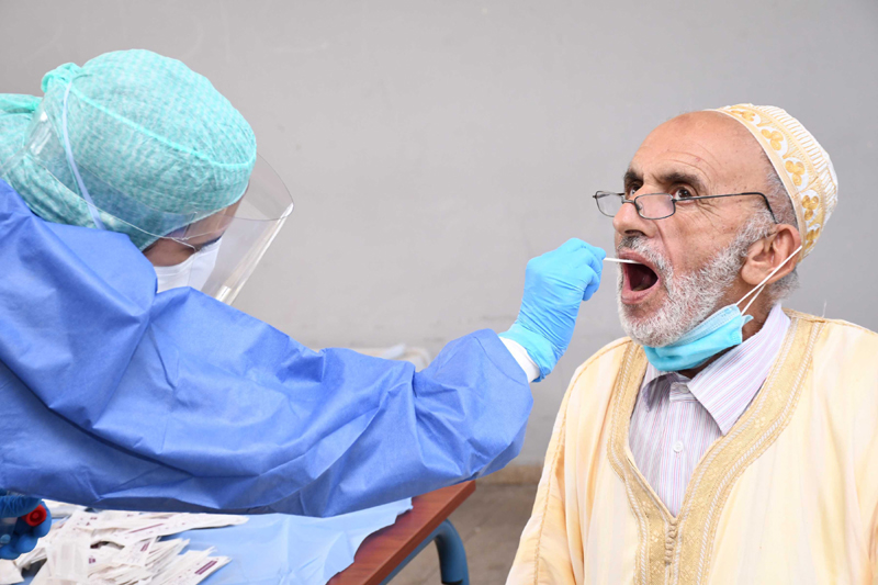 Morocco: A medical worker collects a swab from a man for a COVID-19 test