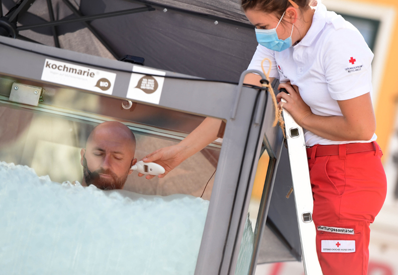 A medical worker checks Josef Koeberl's temperature as he stayed under ice for over 2.5 hrs in Melk, Austria