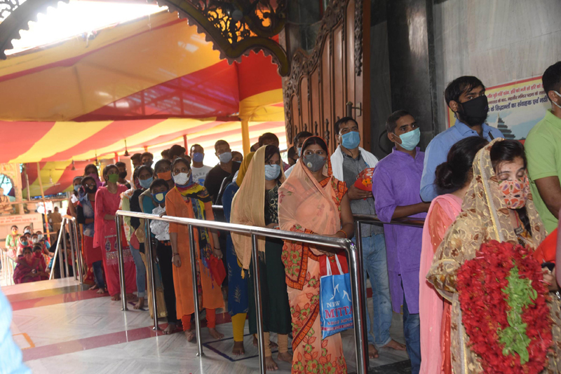 Patna: People wait to enter Mahavir Temple
