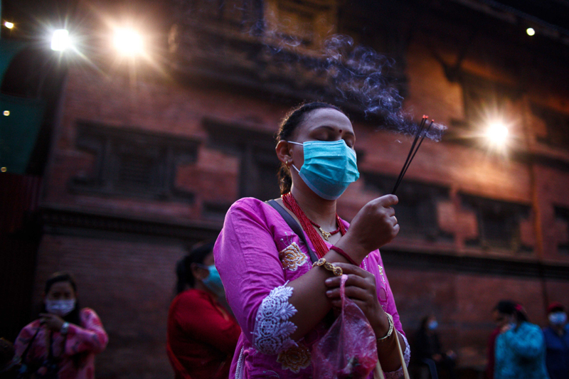 Woman offers prayer on Janmasthami festival at a temple in Nepal