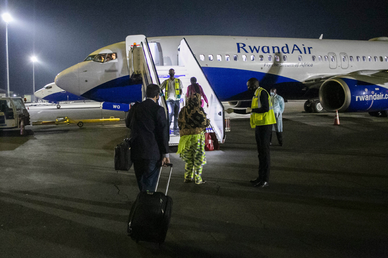 Passengers board RwandAir flight at Kigali as Rwanda opened commercial flights from Aug 1