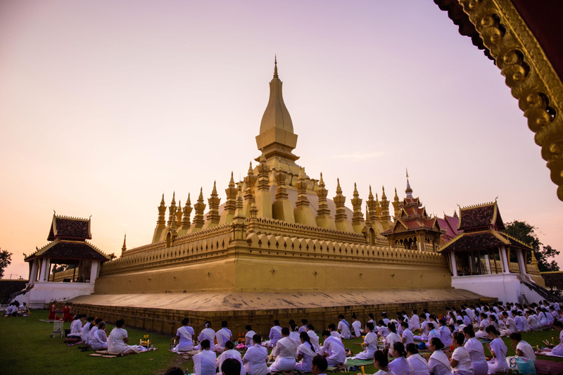 People praying at Luang Stupa in Vientiane, Laos after Covid-19 situation eased