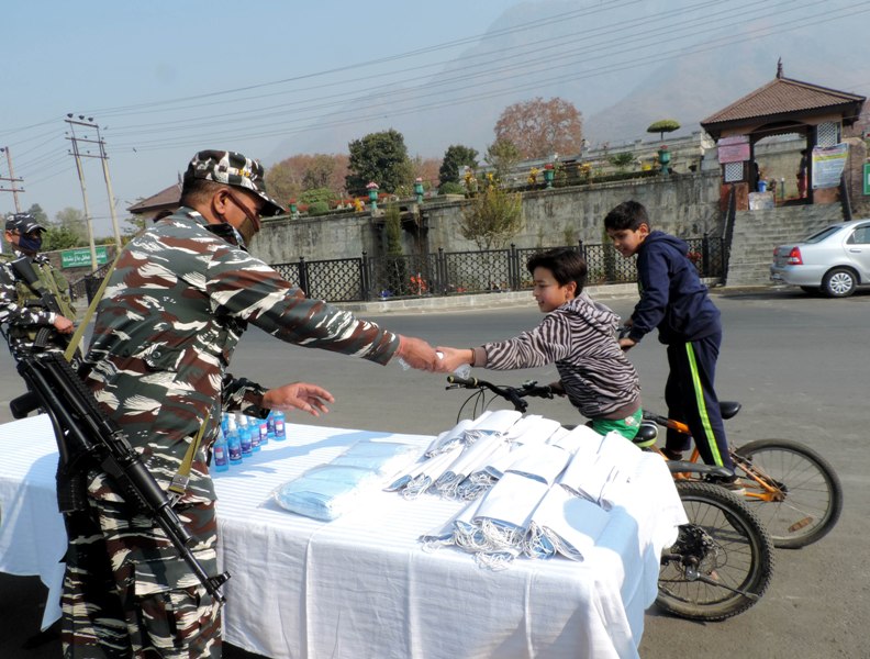 CRPF jawans provides face masks and sanitizer to the local tourists in Srinagar