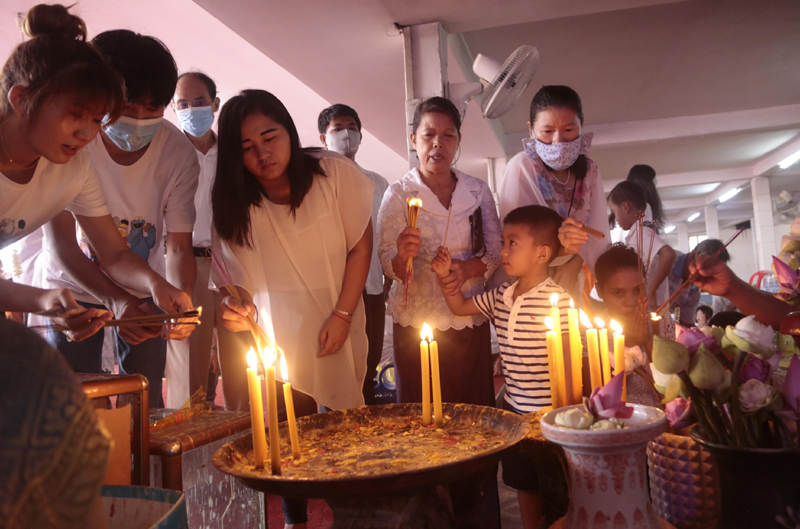 People light incense sticks at a pagoda in Phnom Penh