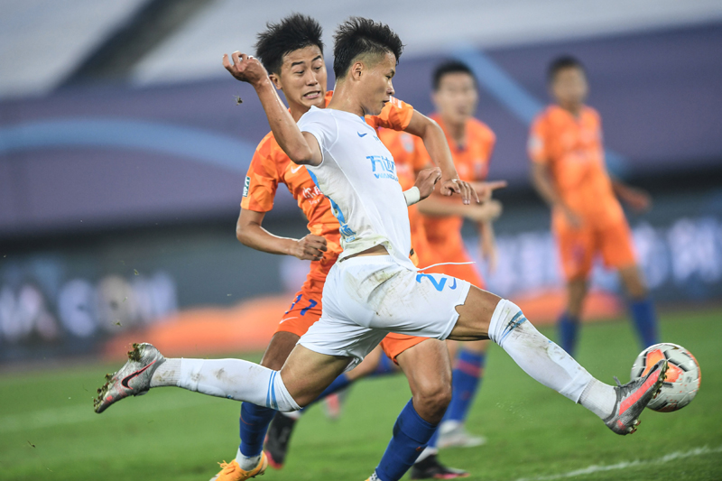 Beijing: Lin Liangming of Dalian FC shoots and scores