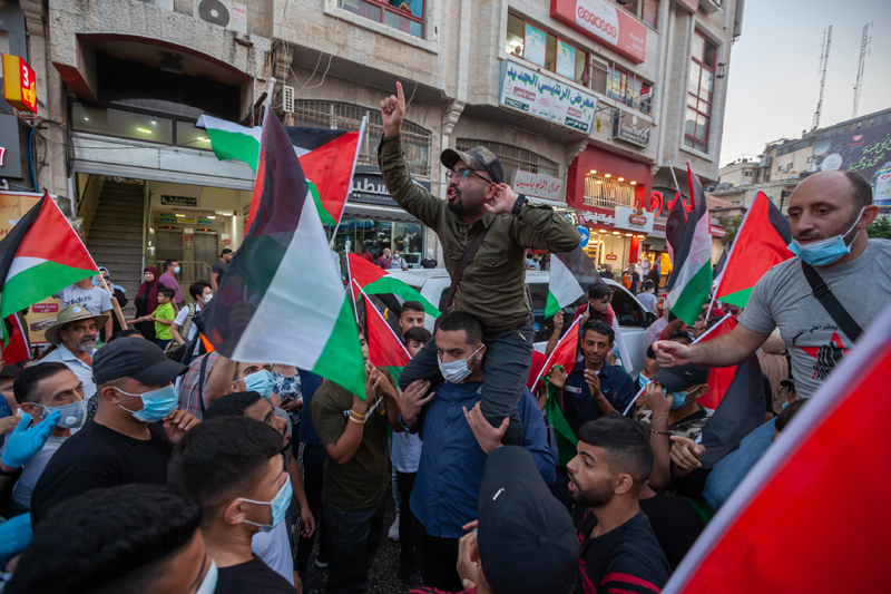 Palestinians take part in a protest against the Arab-Israeli normalization agreements