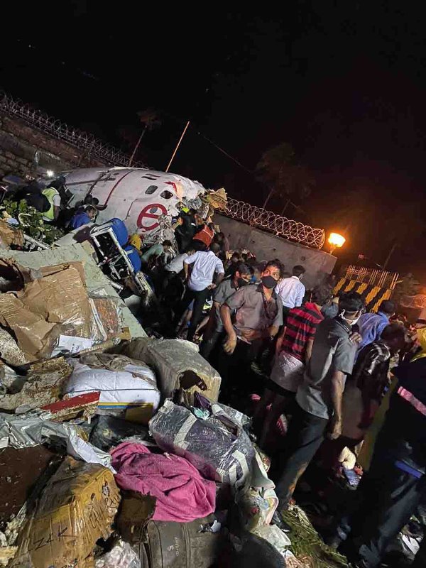 Broken Air India Express Boeing 737 repatriation flight lies amid debris in Kozhikode, Kerala