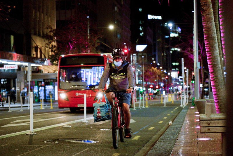 Auckland: Man wearing a face mask rides a bicycle