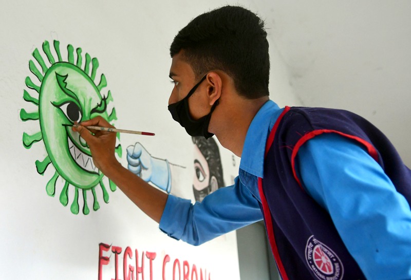 Students create awareness on COVID19 by painting on school wall