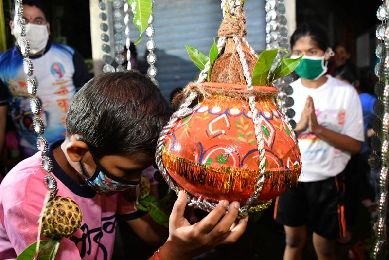 Boy wearing mask breaks earthen pot to mark Janmashtami