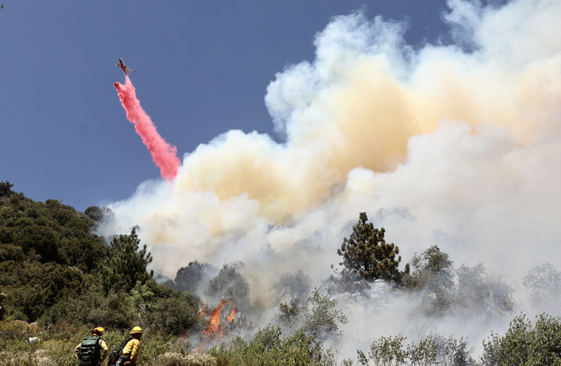 Firefighters battle against a wildfire in Riverside County of Southern California