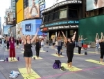 People practicing Yoga at Times Square