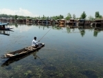 Jammu and Kashmir: Boat man fishing in Dal Lake