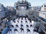 Indian Navy personnel practicing Yoga onboard INS Airavat