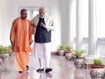 PM Modi interacts with Yogi Adityanath in Raj Bhavan corridor