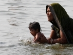 Mother, child takes holy dip in Ganges on Mother's Day