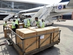 Workers loading emergency medical supplies from Thailand