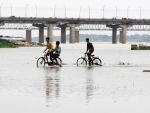 Prayagraj: Boys cycling in the flood water of Ganga