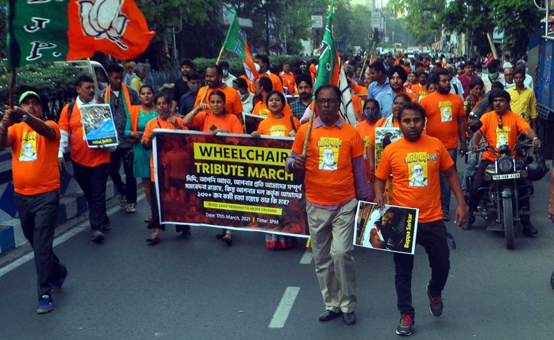 BJP workers in a 'Wheelchair Tribute March' attacking West Bengal CM Mamata Banerjee