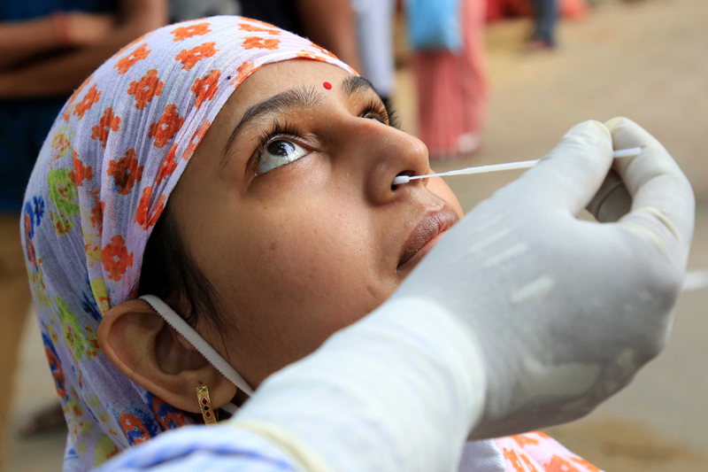 Health workers collect swab in Jamshedpur for Covid test