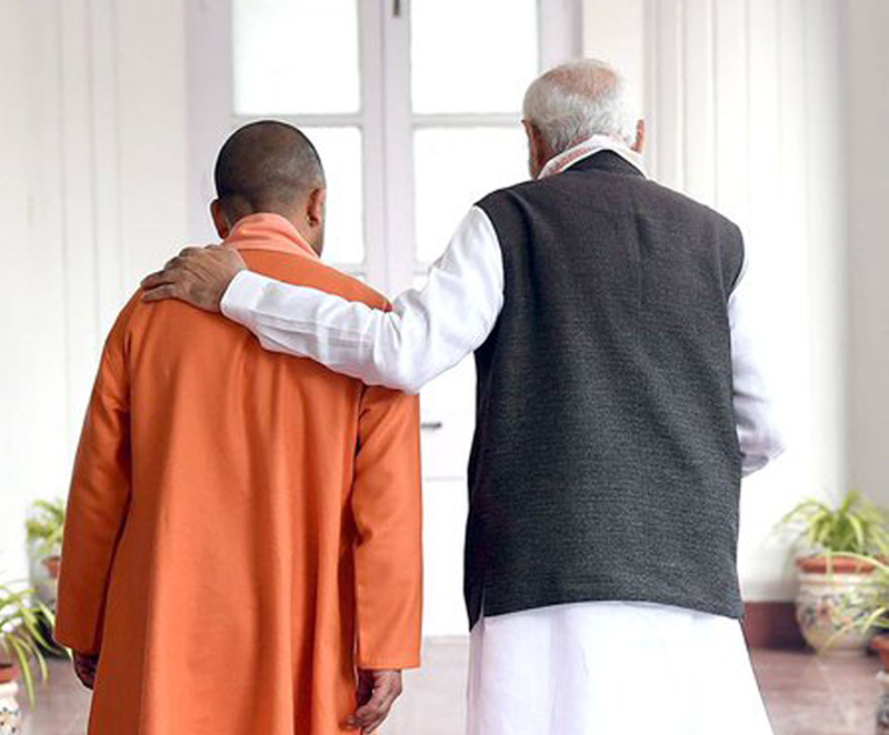 PM Modi interacts with Yogi Adityanath in Raj Bhavan corridor
