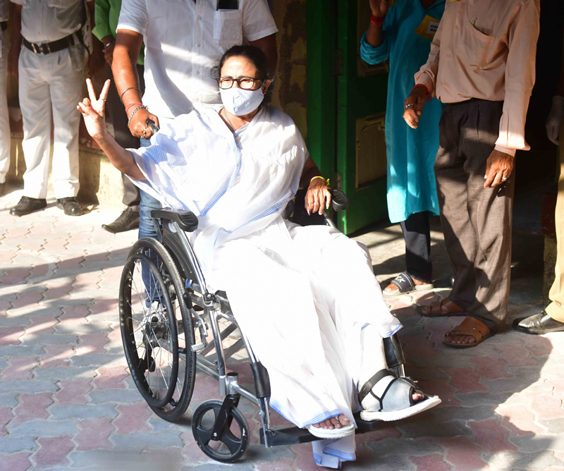Mamata Banerjee sports a victory sign after casting her vote today
