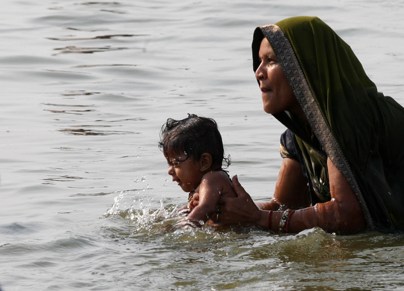 Mother, child takes holy dip in Ganges on Mother's Day