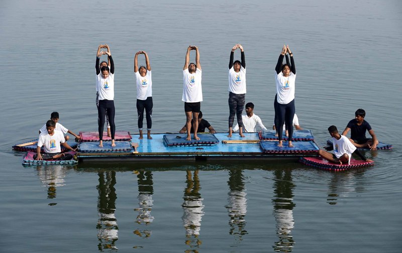 Students of a Water Club perform Yoga