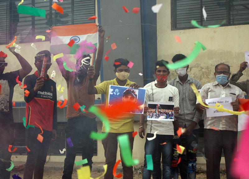 People in India celebrate India's historic win in Australia