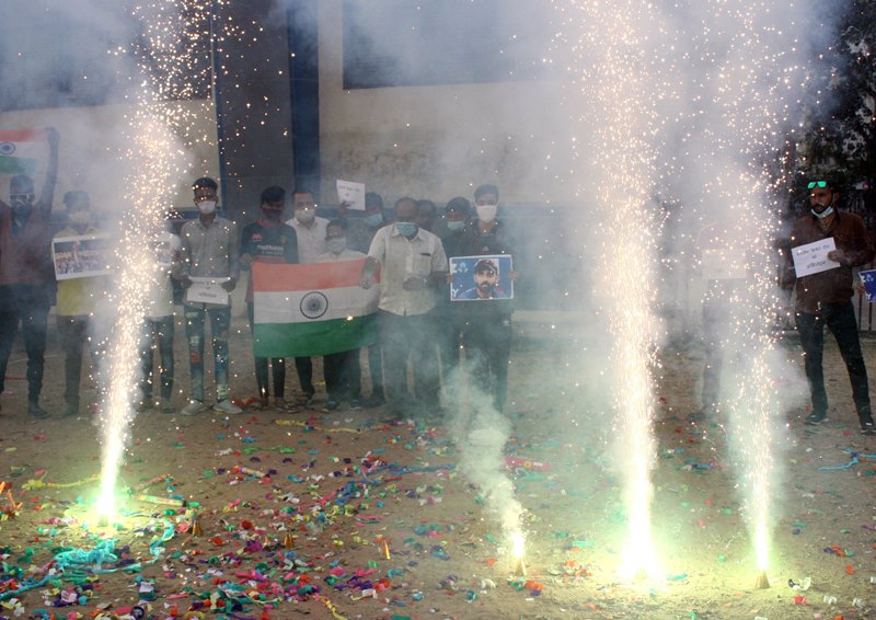 People in India celebrate India's historic win in Australia