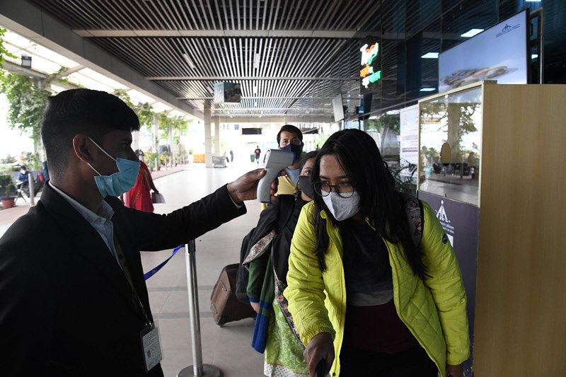 Passengers undergo thermal screening at Patna airport