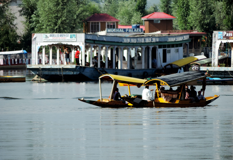 Tourists taking a shikara ride in Srinagar's Dal Lake