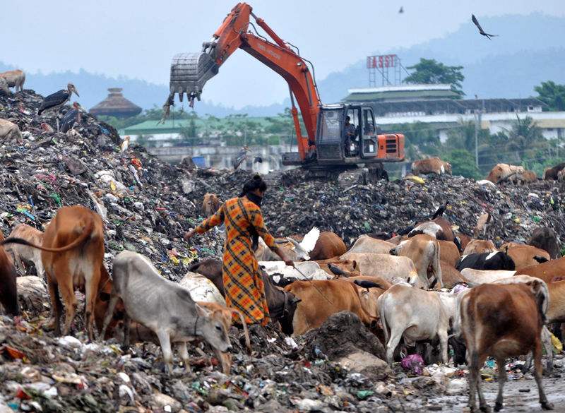 Ragpickers collect reusable items from the garbage dump in Guwahati