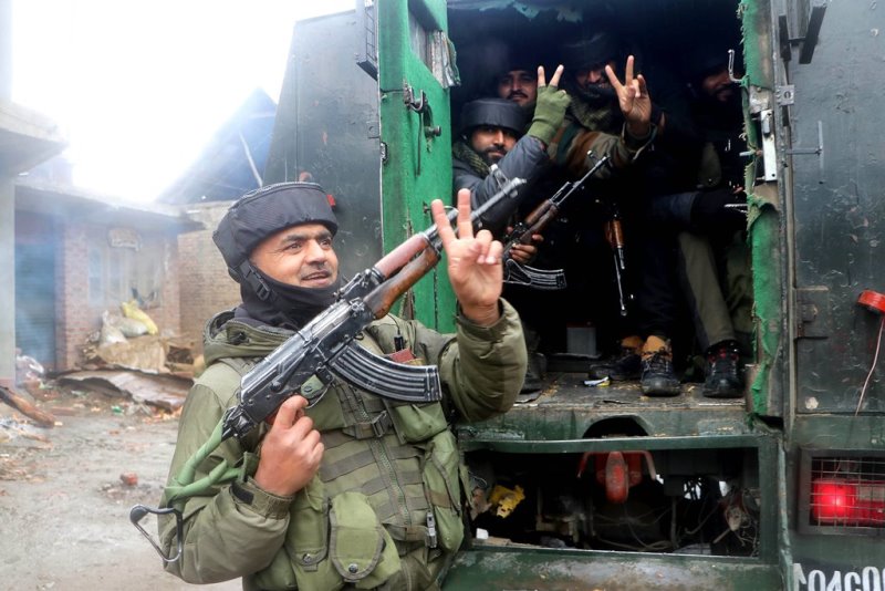 Security personnel flash victory sign after eliminating two LeT terrorists in J&K's Kulgam