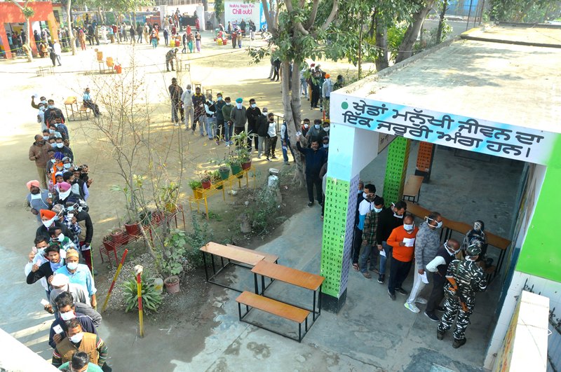 Punjab polls: People wait in queue to cast their votes
