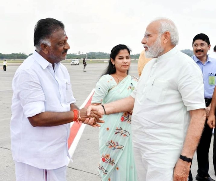 AIADMK Coordinator O Panneerselvam greets PM Modi at Chennai Airport