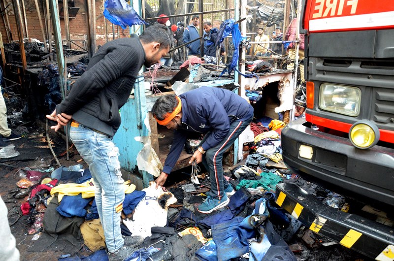 Firefighters extinguishing fire at Delhi's Lajpat Rai market