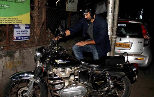 Aditya Roy Kapur takes care of his bike on Sunday
