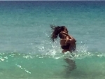 Lisa Haydon enjoys swimming in ocean with her child