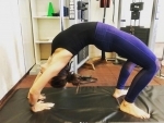 Mimi inspires her fans by posting an image of herself performing stretching exercise 