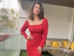 Red dress ignites holiday spirit in Sunny Leone 