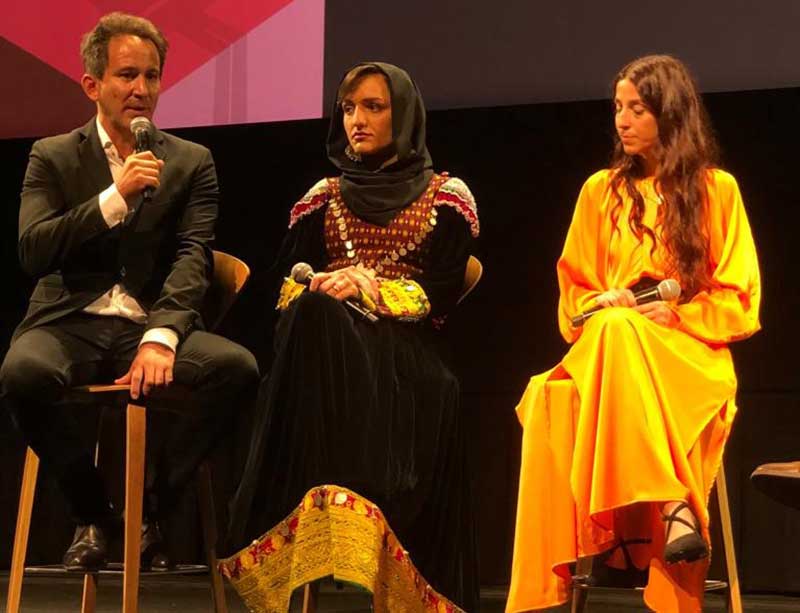 Image credit: TIFF Zarifa Ghafari (middle) and Tamana Ayazi (right) in the press conference