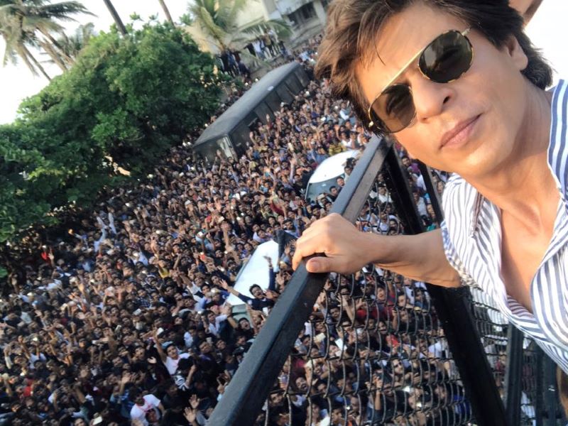 Shah Rukh Khan greeting fans standing outside his Mumbai residence 