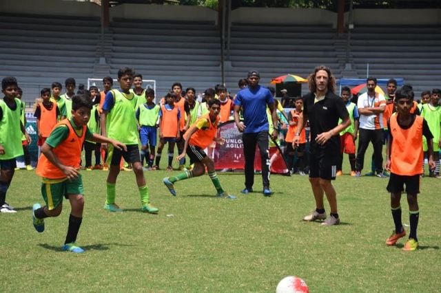 World Cup Winner Carles Puyol plays with school children at Mumbai's MXIM Festival