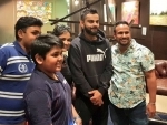 Virat Kohli poses with fans after reaching Australia