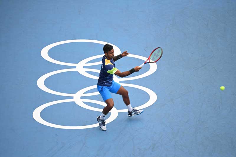 Sumit Nagal of India hits a return during the mens singles second round tennis match between Daniil Medvedev of the Russian Olympic Committee (ROC) and Sumit Nagal of India at the Tokyo 2020 Olympic Games in Tokyo, Japan, July 26, 2021.
