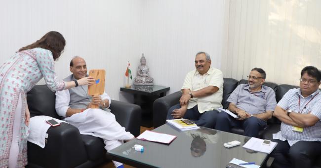Rajnath Singh presenting a cheque to the Union Home Secretary