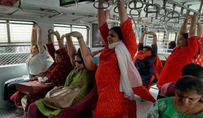 Women on Mumbai locals make good use of their travel time by perform Yoga
